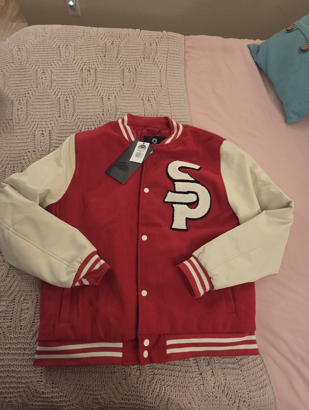 red and cream Southpole men's varsity jacket featuring a prominent "SP" chenille